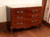 a marble top chest of drawers in the corner of a room