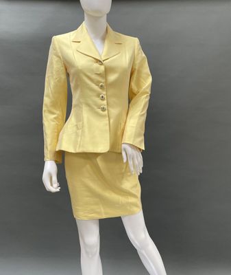 an image of a mannequin dressed in a yellow suit and skirt