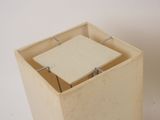 a small square box with a tile inside of it