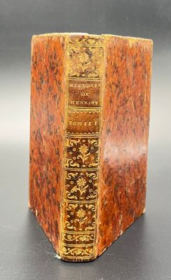 a close up of a book on a table with a black background