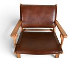 brown leather chair with wooden frame and armrests on white background