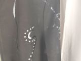 a picture of a man wearing a wet suit with a tattoo on his back