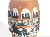 a white vase with a black and orange design on it
