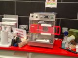 un plan de travail rouge sur lequel est posée une machine à café