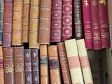 a box full of old books sitting on the floor
