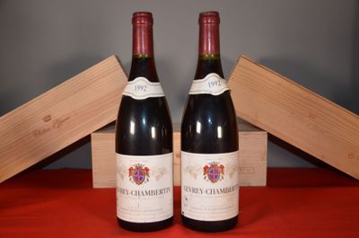 two bottles of wine sitting next to each other on a table