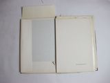 an open book sitting on top of a white table next to a pair of scissors