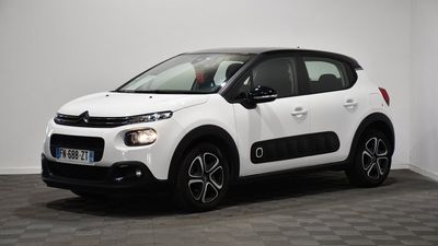a white citrole is parked in a room with a checkered floor