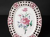 an image of a white plate with pink and blue flowers on it