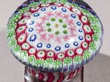 a colorful glass knob with a flower design on it