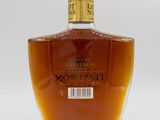 a close up of a bottle of liquor on a white surface