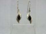 a pair of silver earrings with black stones on them