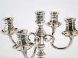 a silver candelab with three candles on it