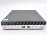 the back view of a small black computer on a white surface
