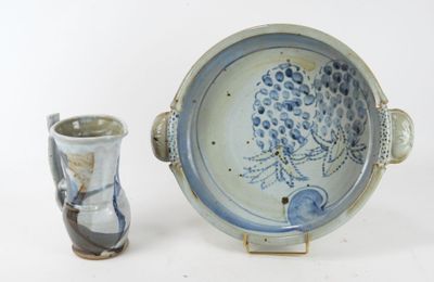 two vases and a bowl sitting next to each other on a table