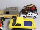 several toy cars and trucks are lined up on a white surface