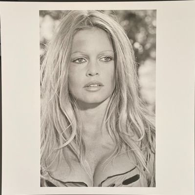 an old black and white photo of a woman with long hair