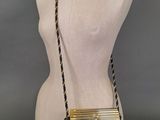 the gold and black purse is on a mannequin mannequin