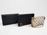 two purses and a wallet sitting on a white surface