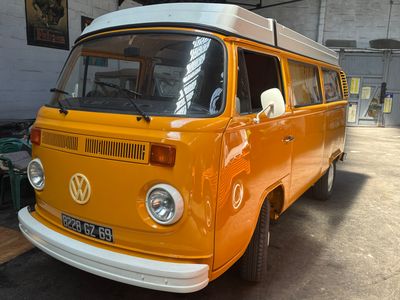an orange vw bus parked in a garage