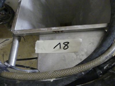 a picture of a stainless steel tank with a hose attached to it