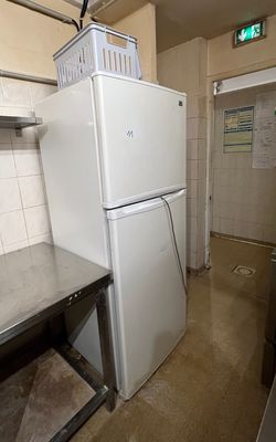 a small kitchen with a refrigerator and a table in it