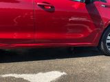 a red car that is parked in a parking lot