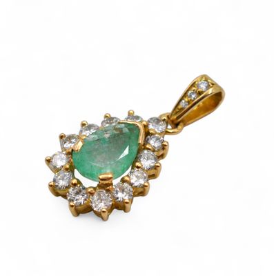 an emerald and diamond pendant on a white background