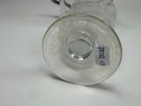 a glass cup with a handle and a label on it