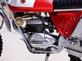 a red and white motorcycle parked on the side of the road
