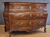 a wooden chest of drawers on a wooden floor