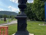 a black urn sitting on the side of the road