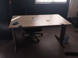 an image of a desk in a dark room with a window