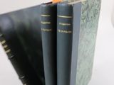 three books stacked on top of each other on a table