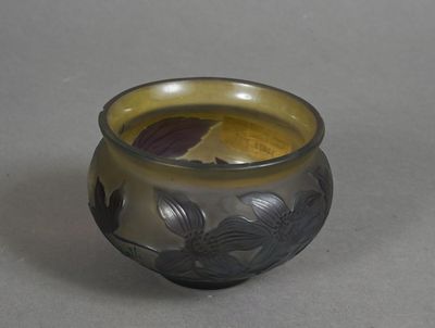 a small glass vase that has a flower design on it