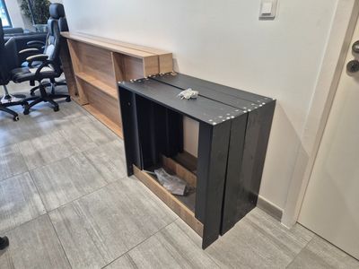 a black suitcase sitting on top of a desk in a room