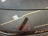 a close up of a car ' s hood with a ruler on it