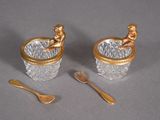 two cups and spoons sitting on a table
