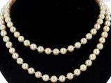a close up of a necklace with pearls on a mannequin