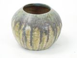 a close up of a vase on a white surface