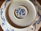 a blue and white plate sitting on top of a wooden table