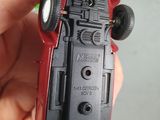 a person holding a toy car in their hand