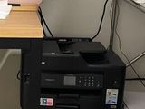 une imprimante posée sur un bureau à côté d'une imprimante
