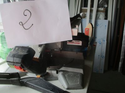 a sign that says s on a piece of paper on a cluttered desk