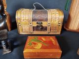 a wooden box with a painting on it next to other items