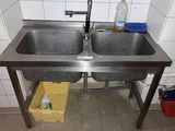 a stainless steel sink with two sinks underneath it