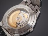 a close up of a watch on a black surface