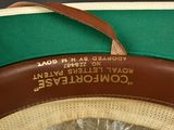 a green hat with a brown band and a brown hat with a brown band
