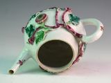 a tea pot with a handle that has flowers on it