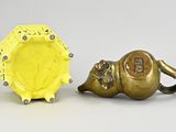 pair of antique brass elephant figurines and a yellow plate